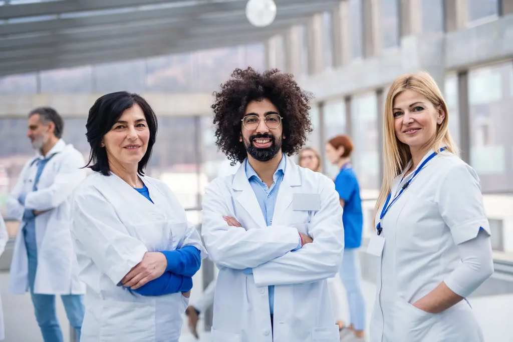 Group of confident medical professionals standing together, representing doctors and healthcare workers seeking debt relief for student loans in Dallas.